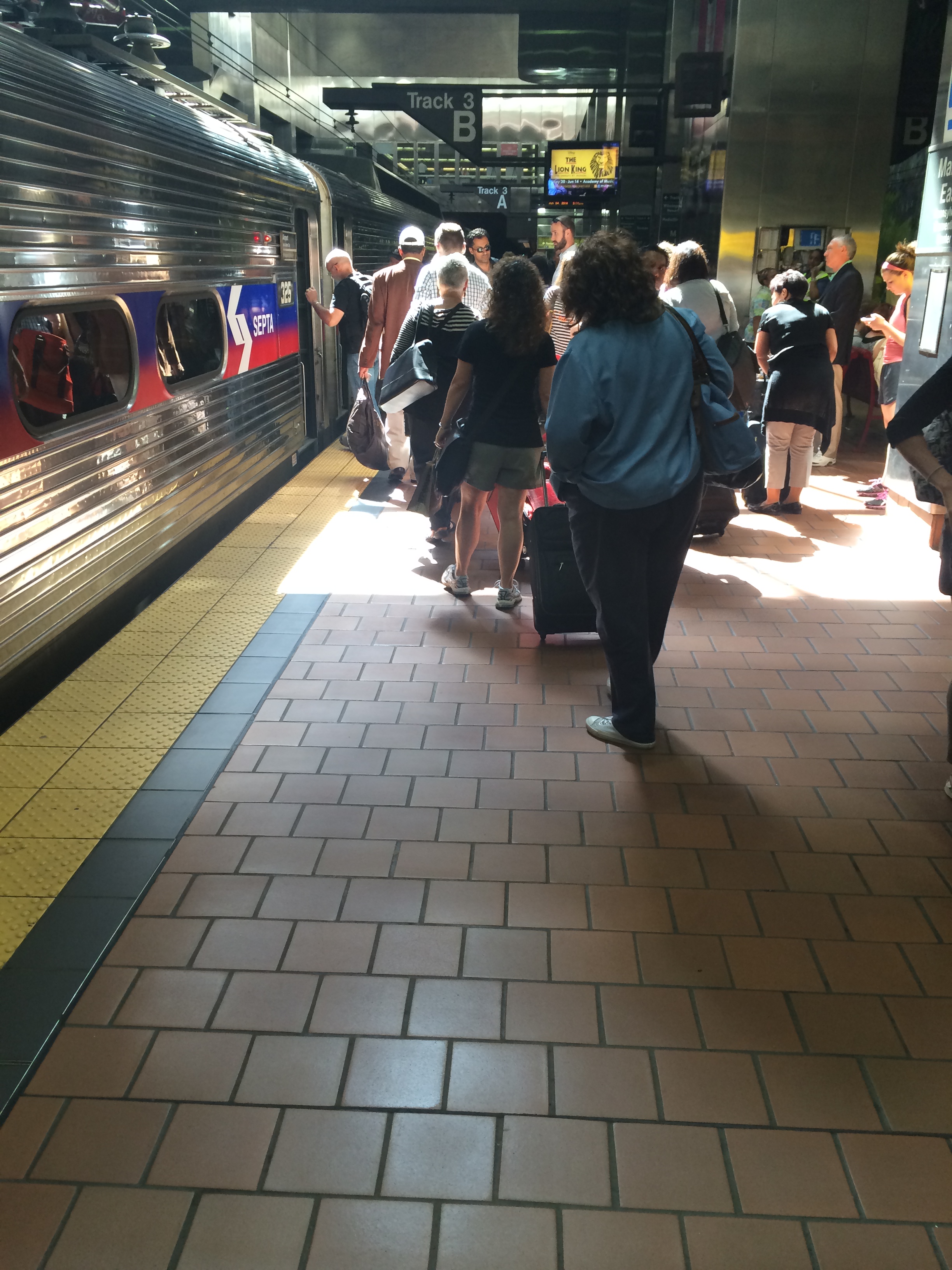 Airport train boarding in Center City. Rear door of second car isn't open, creating a bottleneck of people at the center door.